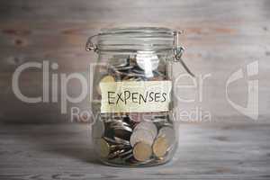 Money jar with expenses label.