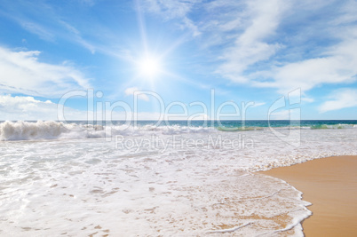 ocean, sandy beach and blue sky