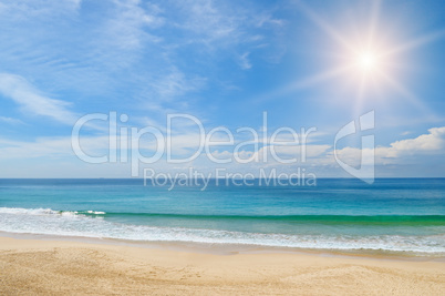 ocean, sandy beach and blue sky