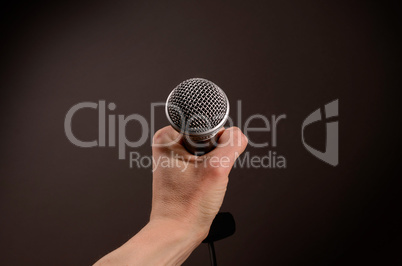 Hand with a microphone