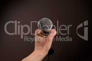 Hand with a microphone