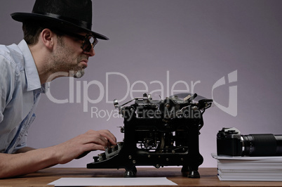 Agent with an old type writer and a vintage camera