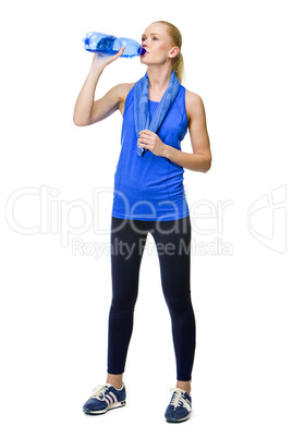 woman in fitness clothing drinking