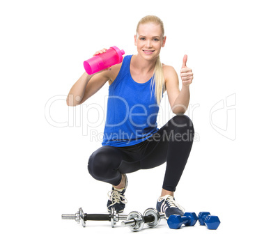 woman in fitness clothing drinking