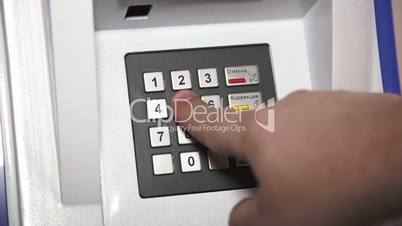 Human hand enter pin code on ATM