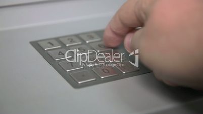 Human hand enter pin code on ATM