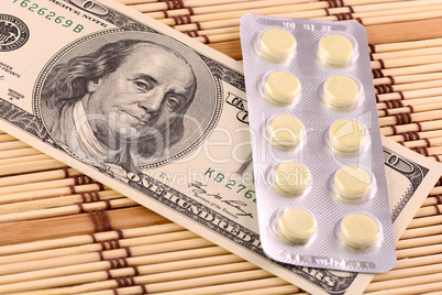 Pills and american money close-up background