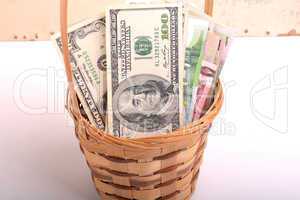 money set in a basket, dollars, euro and ukrainian money