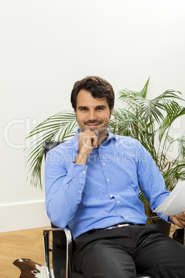 Young man reading written agreements for work