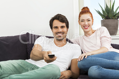 Happy Young Sweet Couple Sitting at the Couch