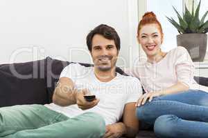 Happy Young Sweet Couple Sitting at the Couch