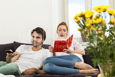 Couple Resting on the Sofa at the Living Room