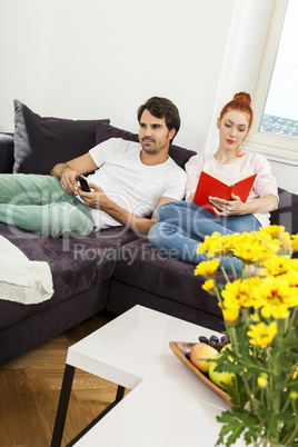 Couple Resting on the Sofa at the Living Room