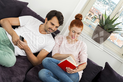 Couple Resting on the Sofa at the Living Room