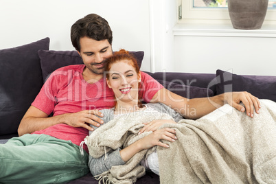 Couple Resting on the Sofa at the Living Room