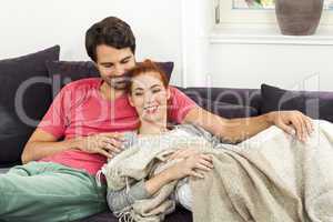 Couple Resting on the Sofa at the Living Room