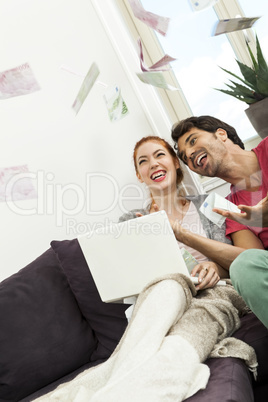 Sitting Happy Couple Throwing Money in the Air