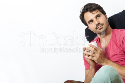 Man Sitting on Chair with Book and a Drink