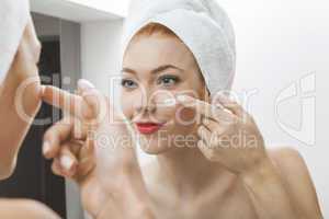 Woman After Shower Applying Cream on her Face