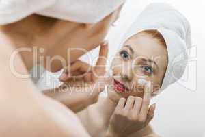 Woman After Shower Applying Cream on her Face