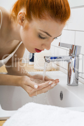 Woman Washing her Face While Looking at the Camera