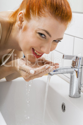 Woman Washing her Face While Looking at the Camera