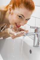 Woman Washing her Face While Looking at the Camera