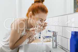 Woman Washing her Face While Looking at the Camera