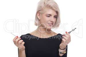 Blond Woman Holding a Tobacco and E-Cigarette