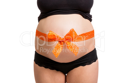 Pregnant woman wearing a bow on her belly