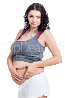 Young pregnant woman making a heart gesture