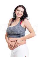 Young pregnant woman making a heart gesture