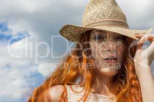 Gorgeous Woman in Hat on Cloudy Sky background