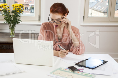 Young Businesswoman Looking at Computer Seriously