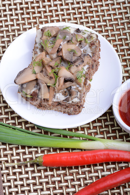 mushroom salad on white plate and red pepper