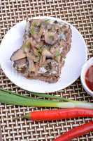 mushroom salad on white plate and red pepper