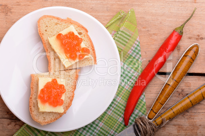 sandwich with red caviar on white plate