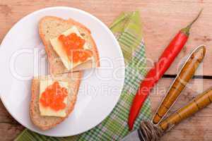 sandwich with red caviar on white plate