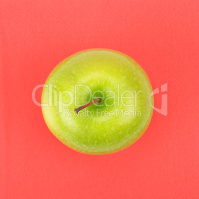 Green apple on a red napkin