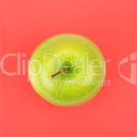 Green apple on a red napkin