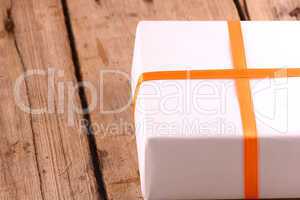 white gift box on wooden plate