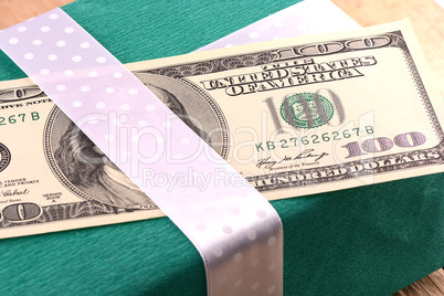 american money with green gift box