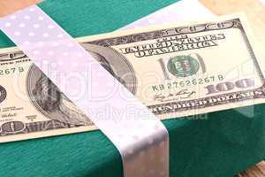 american money with green gift box