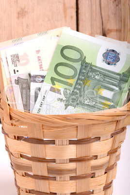 european money on wooden basket