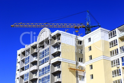 construction of multistorey modern house with hoisting crane