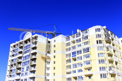 construction of multistorey modern house with hoisting crane