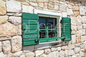 Built Old windows with shutters in a wall of stone