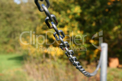 A metal chain on a green background