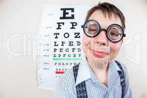 Person wearing spectacles in an office at the doctor