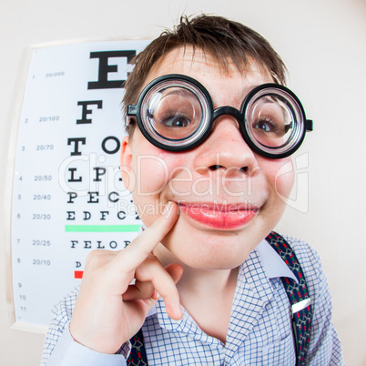 Person wearing spectacles in an office at the doctor